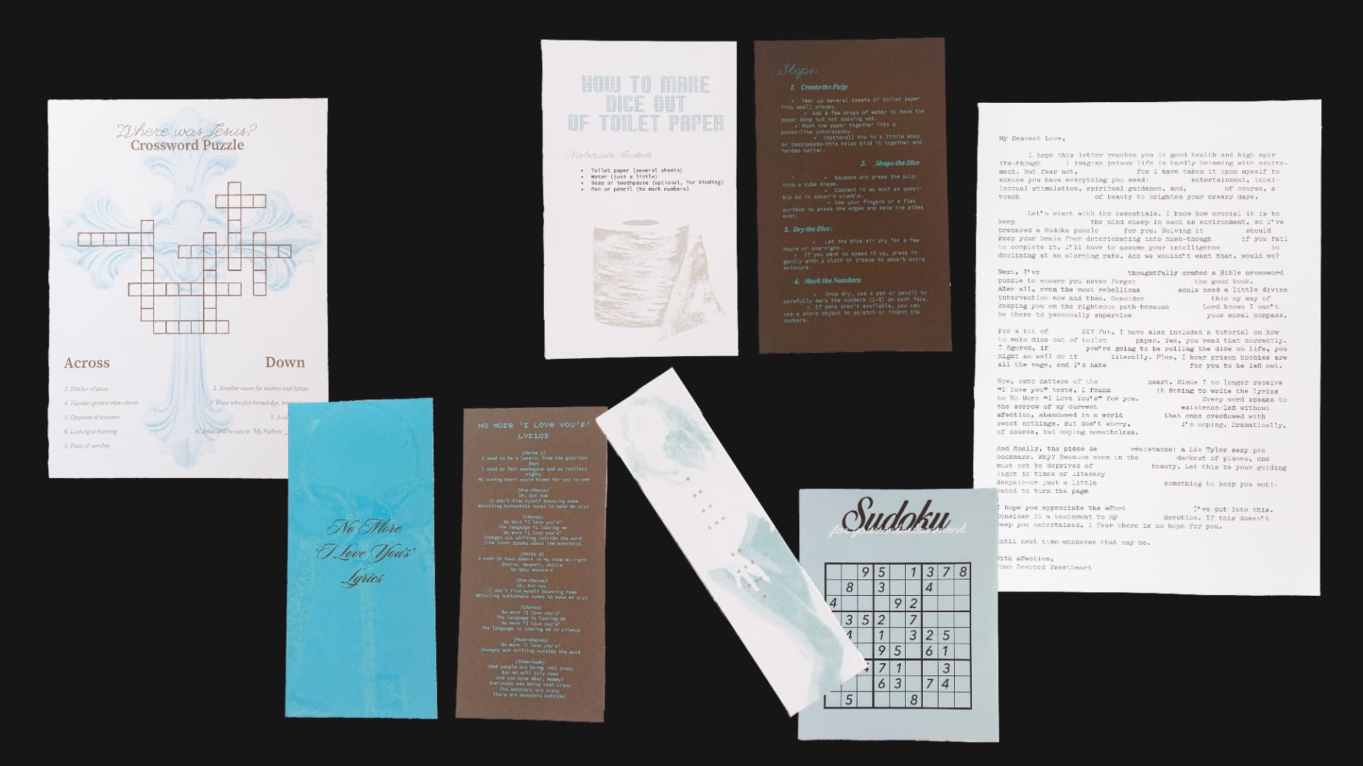 The full contents of the envelope laid out: crossword, dice tutorial, letter, lyrics, bookmark and sudoku