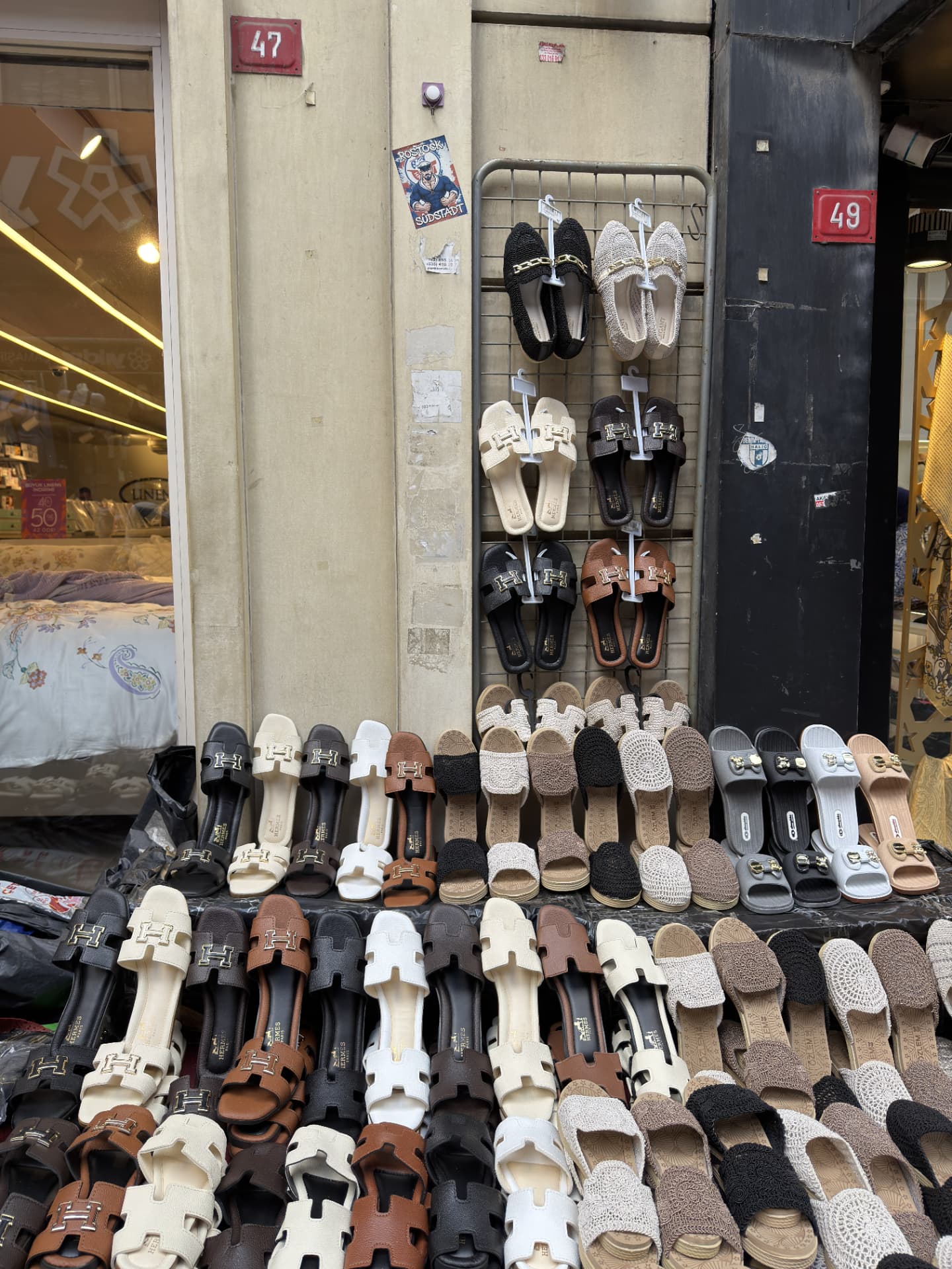 Outdoor display of imitation-branded sandals